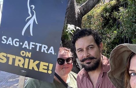 Three people stand on a picket line holding signs in this image from Chrissy Metz / Instagram