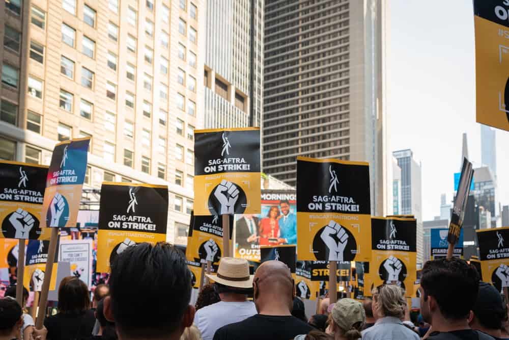 A crowd of SAG-AFTRA members holding their picket signs in this image from Shutterstock